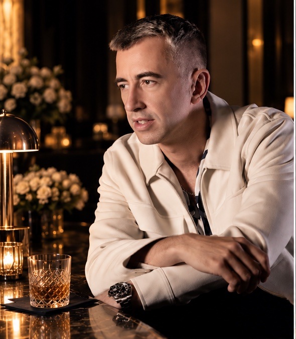 Theo Grange in a cream jacket at an intimate bar